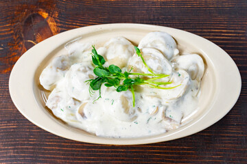 Delicious dumplings served in creamy sauce with fresh herbs