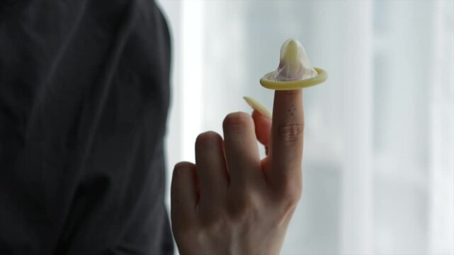 verticalCondom in female hands close-up.
Girl unpacks condom.
Condom with lubricant.
Safe sex and sex education.
Condom, sex, orgasm, penis, hands