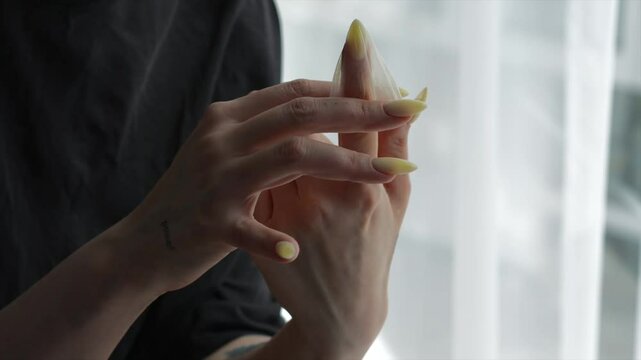 verticalA girl with long nails holds an unsealed condom in her hands after use.
A means of contraception against viruses and diseases.
Sexually transmitted diseases