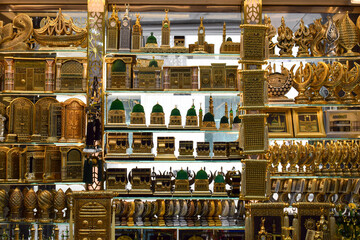 Madinah, Saudi Arabia - March 3, 2025: A golden miniature souvenir of the Prophet's Mosque and the Kaaba is displayed in a shop, as a gift for Hajj and Umrah pilgrims.