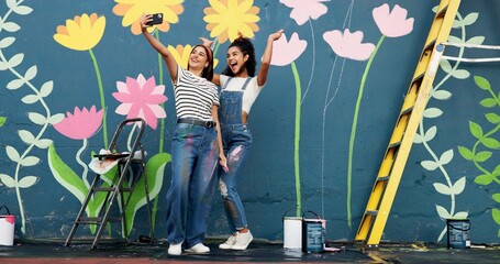 Outdoor, artist and women with mural, selfie and friends with smile for painting, online and social media. Bonding, painter and people with photography for wall art, post and creativity with decor © peopleimages.com