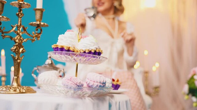 blurred silhouette woman queen sitting at dinner table drinking hot tea dessert cakes pies marshmallows sweet confectionery. Fantasy Girl princess having breakfast Victorian style room, vintage dress