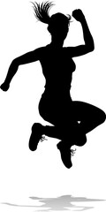 A happy woman jumping for joy in mid air silhouette person concept