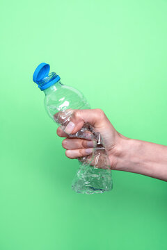 Squeezing a plastic bottle to promote recycling