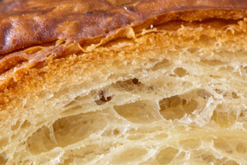 Macro shot of crispy golden bread crust and soft porous crumb.