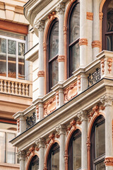 Ornate historic facades with arched windows, balconies, and rich stucco decoration in the Via XX Settembre district, showcasing the city’s eclectic and Liberty-style architecture.