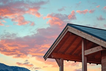 Wooden cabin roof under a vibrant sunset sky.