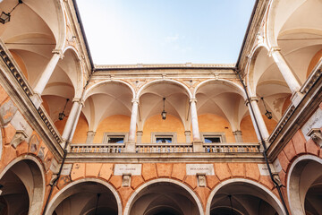 Elegant Renaissance courtyard with marble columns and vaulted arches inside Palazzo Doria-Tursi on Via Garibaldi.