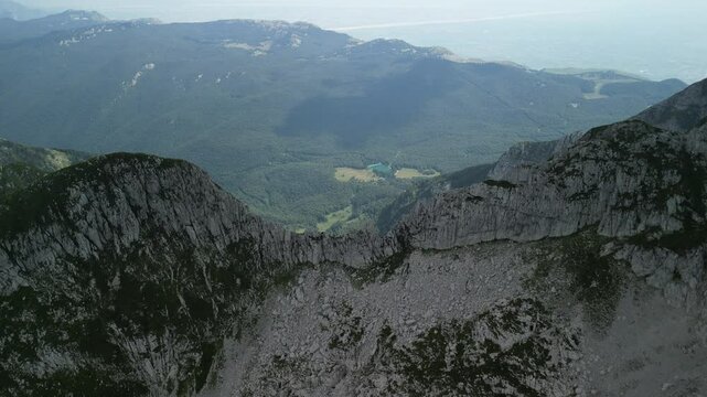 rocky mountains under a cloudy foggy sky in summer in Levico Terme, Italy
