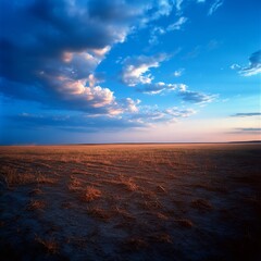 Serene panorama of a vast plain with dramatic sky and captivating clouds