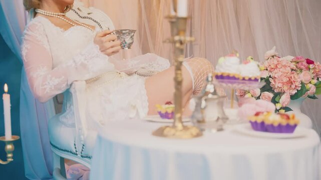 blurred silhouette woman queen sitting at dinner table drinking hot tea dessert cakes pies marshmallows sweet confectionery. Fantasy Girl princess having breakfast Victorian style room, vintage dress