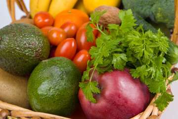 fresh vegetables and fruits in a wooden basket, healthy eating and vegetarian.