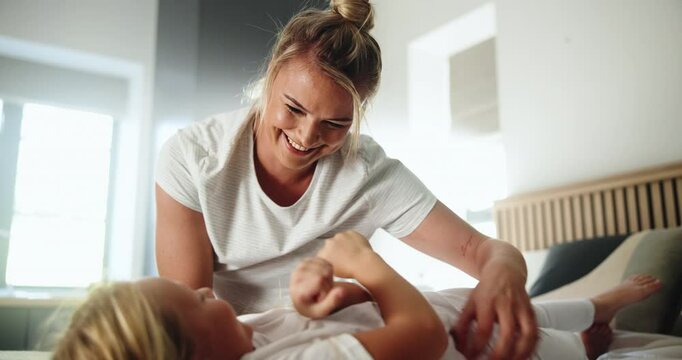 Home, mother and child with tickle for playing, laughing and bonding together in loving relationship. Bedroom, mom and girl with funny game for connection, childhood activity and support with trust