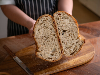 Artisan Sourdough Bread in Hand – Fresh from the Oven.