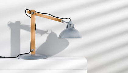 Retro or vintage style desk lamp, classic wooden arm with metal base and grey colored canopy, against white background, isolated.   