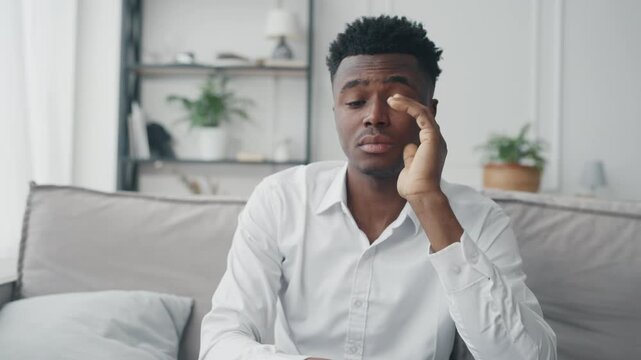 Lonely African American man thinking about problems of life, psychology. Handsome young black guy feeling sadness, depression and anxiety, divorce or lose work, financial troubles of modern people