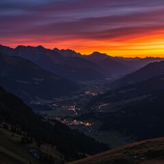 Fototapeta premium Vibrant Sunset over Alpine Valley and Mountain Range