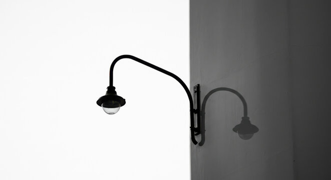 Modern Minimalist Wall Sconce Lighting Fixture in Dark Interior Setting with Warm Glow