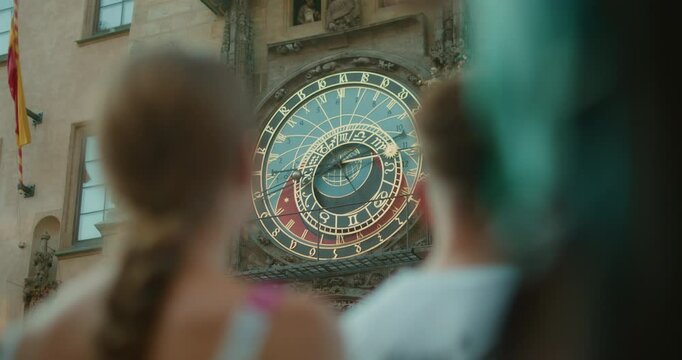 Astronomical clock in Prague, Czech Republic, with tourists watching its detailed moving mechanisms