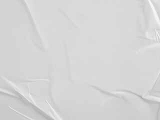A white crumpled paper with folds and wrinkles, the background is a plain white surface, creating a abstract composition.