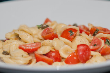 Shell pasta with cherry tomatoes and herbs — simple Mediterranean vegetarian dish
