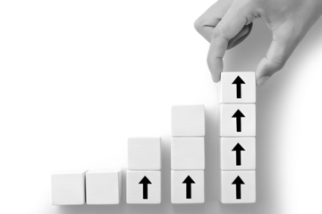 Growing graph made of blocks and up arrows. Steps of growth. Enlargement and growth concept. Career, economics. Statistics and news. Skills and self-development concepts