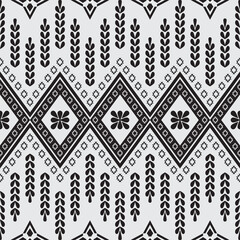 A black-and-white geometric pattern inspired by traditional textile designs. Featuring symmetrical diamond shapes, floral motifs, and vertical repetitive elements.