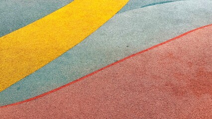 Texture of color rubber floor on playground. Colorful Safety Rubber Floor with Slide and Playground Equipment.