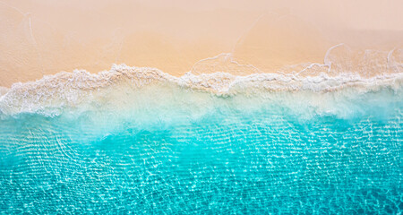 Stunning aerial top view summer sandy beach, pristine crystal clear sea water golden sand vibrant coastal vibes perfect for travel vacation nature photography. Calm waves, amazing landscape wallpaper