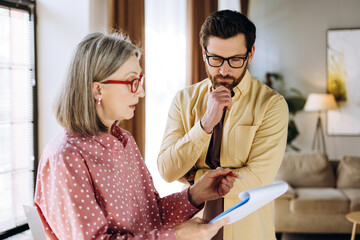 Business people discussing and analyzing data in office meeting