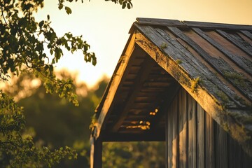 Rustic wooden structure roof at sunset.