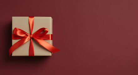 Elegant Gift Box with Red Ribbon on Maroon Background