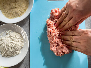 Woman hand knead fresh minced meat close-up, prepare cooking tasty cutlets