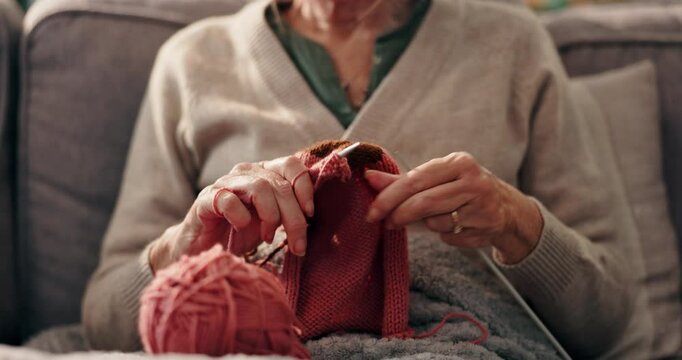 Hobby, hands and senior woman knitting in home for mental engagement, activity or creativity. Closeup, retirement and elderly female person with needles and wool for handmade clothes in living room.