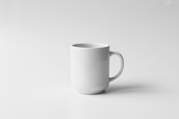Fototapeta premium A white coffee cup sits on a white table