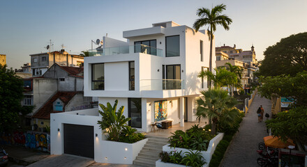Fototapeta premium Modern Villa Exterior Architecture and Tropical Streetscape at Golden Hour