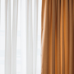 Fototapeta premium sheer white curtains and golden drapes in a well-lit room