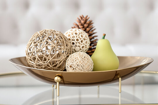bronze bowl with wicker balls pine cone and pear-shaped decorative object
