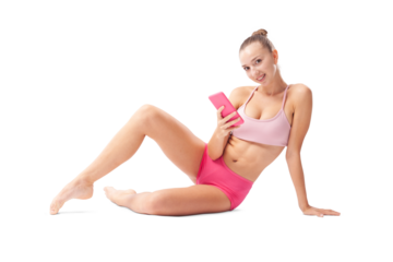 Smiling young woman training in artistic gymnastics, a rhythmic gymnast taking a break and using her phone. Sports workout, fitness, and well-being concept, isolated on white background