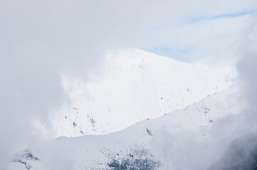 Dramatic snow cornice on high mountain slope
