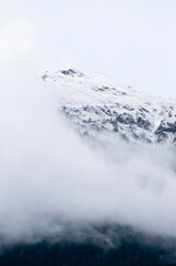 Mountain peak fading into dense clouds