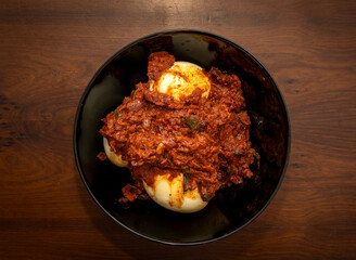 Kerala Style Egg Curry of Egg Roast In Black Bowl
