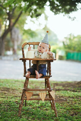 Boy crash his first smash cake in the park