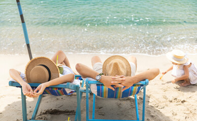 A little happiness of a lovely family with a summer vacation, having fun on the beach, clear sky.
