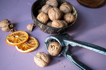 shelled walnuts and metal nutcracker in close-up	