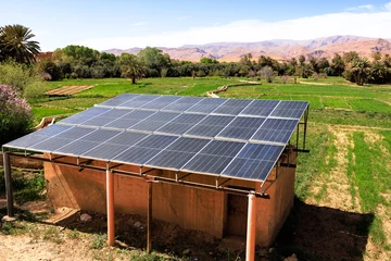 Fotobehang Afrika Solar panels providing sustainable energy in Tinghir palm grove  © mariamontoyart