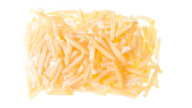 Packaging and Freezing Fresh French Fries. French fries are vacuum packed and rapidly cooled by an ice jet, creating a white steam effect on a white background