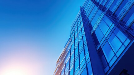 Modern skyscraper reaching into the blue sky during sunset, showcasing architectural design