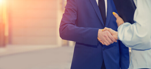 Handshake close-up. Business partners, man and woman. Concept of new team members, cooperation.