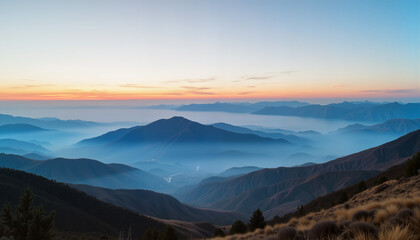 Obraz premium Misty Mountains at Sunrise with Vibrant Horizon 